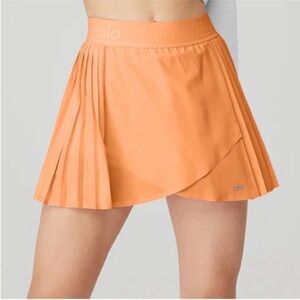 ALO Yoga Women's Aces Tennis Skirt in orange Canteloupe size XS